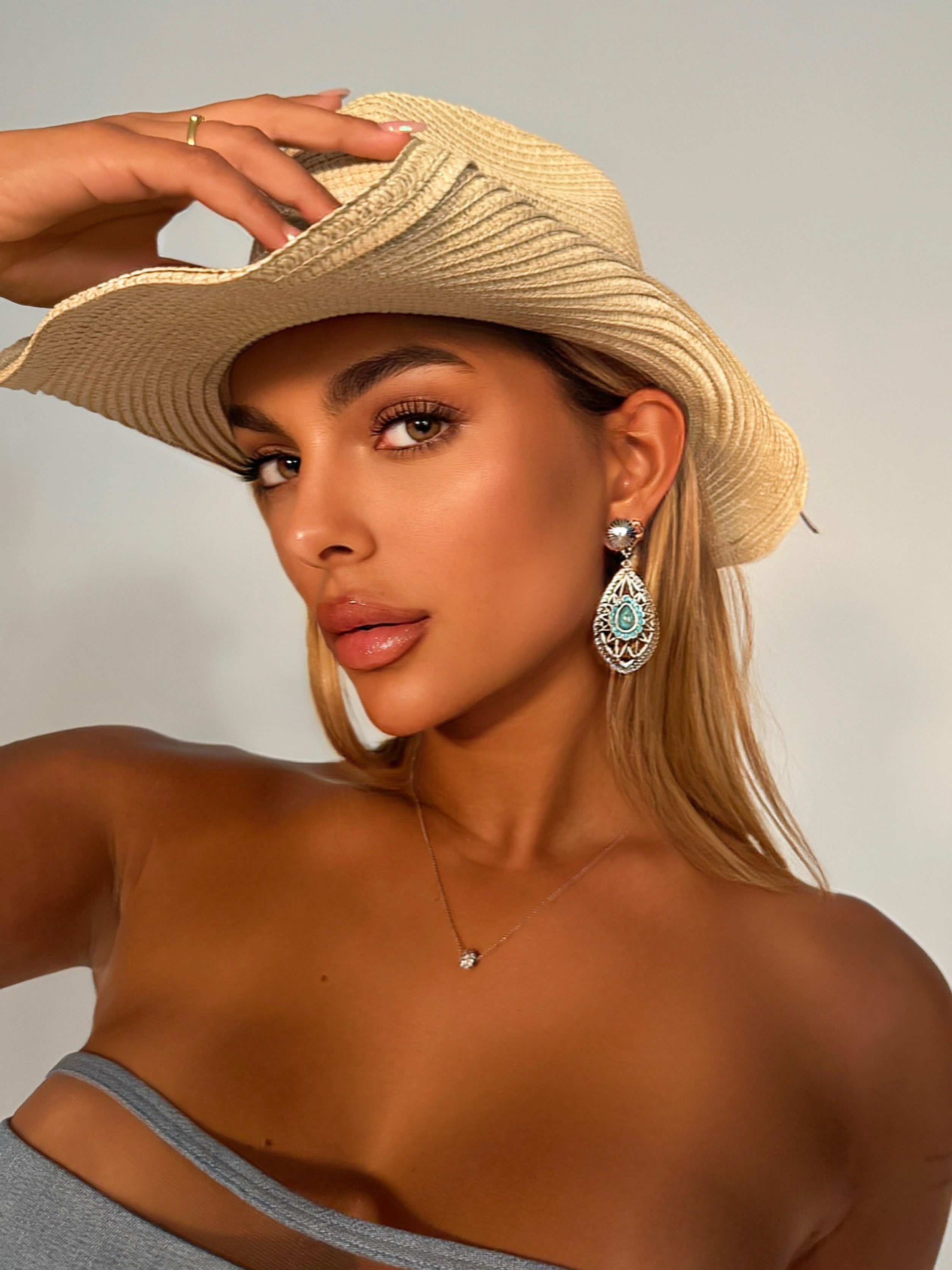Woman wearing large blue earrings