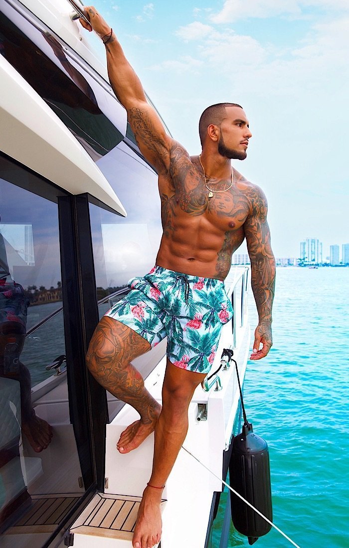 a man wearing a Flamingo Drive Swim Shorts  at the beach- OMG Swim